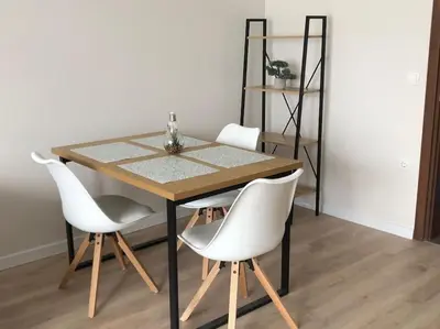 a dining room table with white chairs and a shelf at *HOT* Main Square Brand New Luxury Apartment in Burgas City