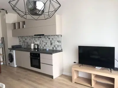 a kitchen with a stove and a tv in a room at *HOT* Main Square Brand New Luxury Apartment in Burgas City