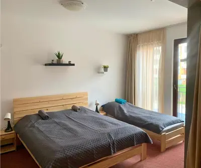 a bedroom with two beds and a window at Ubytování krásném a klidném prostředí V soukromém apartmánu in Aheloy