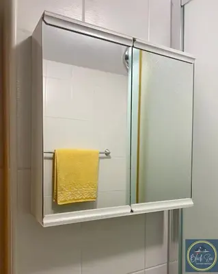 a mirror in a bathroom with a yellow towel at Scenic, 2 Bedroom Apt with Views in Kableshkovo