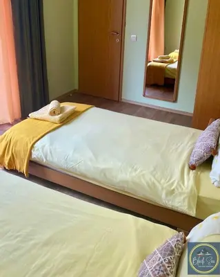 a bedroom with two twin beds and a mirror at Scenic, 2 Bedroom Apt with Views in Kableshkovo