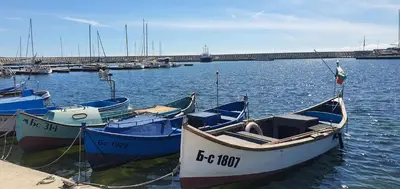 three boats are docked in the water in a harbor at K&K Sunset in Burgas City