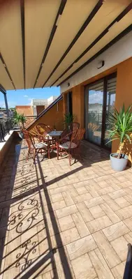 a patio with chairs and a table on a building at K&K Sunset in Burgas City
