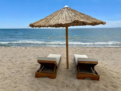 two chairs under an umbrella on the beach at ONYX 1 - Menada Apartments in Sveti Vlas