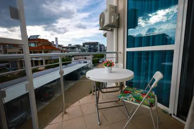 a balcony with a table and chairs on a balcony at Sunset Apartment Atlantis Resort in Burgas City
