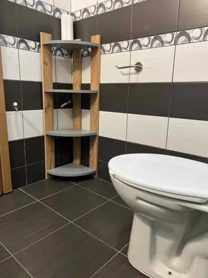a bathroom with a toilet and black and white stripes at Lazur Apartment AQUA in Burgas City