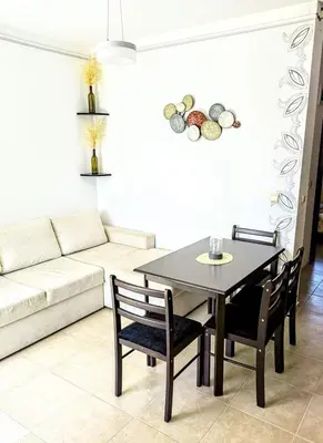 a living room with a table and chairs and a couch at Apartament Morela in Sunny Beach