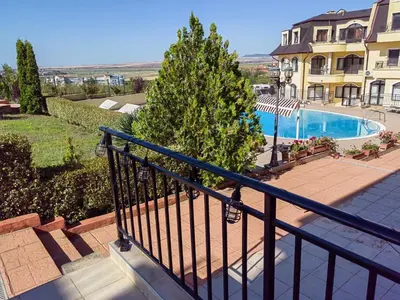 a balcony of a building with a swimming pool at Apartament Morela in Sunny Beach