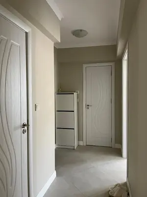 an empty hallway with a white door and a room at Varna City Center Apartment in Varna City