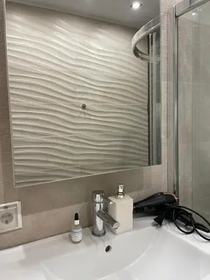 a bathroom sink with a faucet and a mirror at Varna City Center Apartment in Varna City