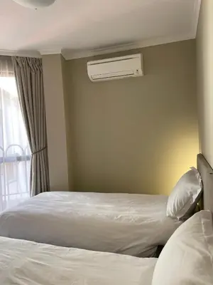 a bedroom with a bed and a air conditioner at Varna City Center Apartment in Varna City