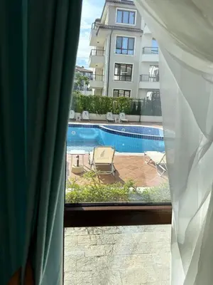 a view of a swimming pool from a window at Pool apartment on the beach in Burgas City