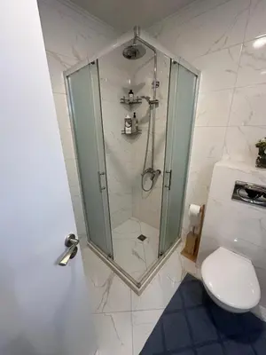 a bathroom with a shower and a toilet at Pool apartment on the beach in Burgas City