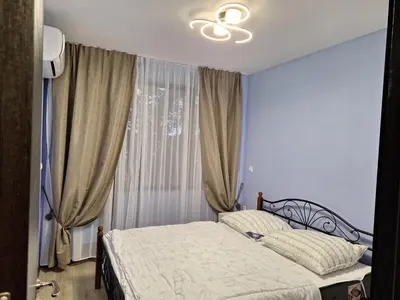 a bedroom with a bed in front of a window at Apartment102 Green Paradise Primorsko in Primorsko
