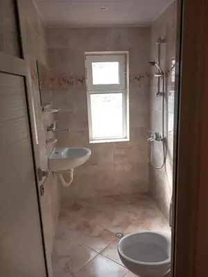 a bathroom with a sink and a toilet and a window at Лятна вила Генчеви град Обзор in Obzor