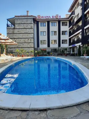 a large blue swimming pool in front of a building at Апатаменти за гости Sunshine и Glory in Sveti Vlas