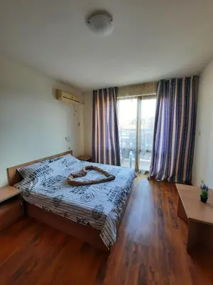 a bedroom with a bed and a large window at Апатаменти за гости Sunshine и Glory in Sveti Vlas