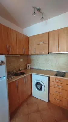 a kitchen with a washing machine and a sink at Seafront apartment Lucky in Sveti Vlas