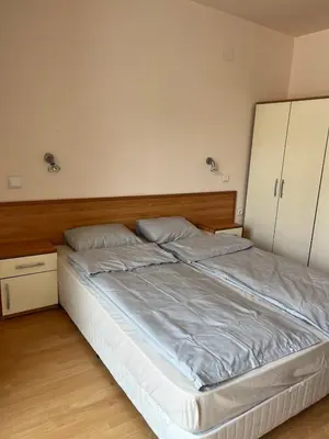a bedroom with a large bed with white cabinets at Seafront apartment Lucky in Sveti Vlas