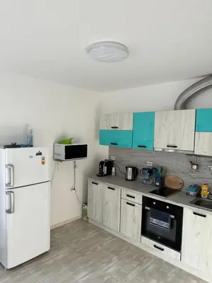 a kitchen with a refrigerator and a white refrigerator freezer at Marteo Apartments103 - Sozopol in Sozopol