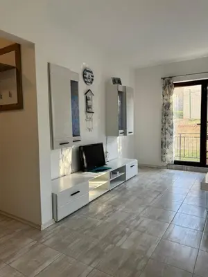 a white living room with a laptop on a desk at Marteo Apartments103 - Sozopol in Sozopol