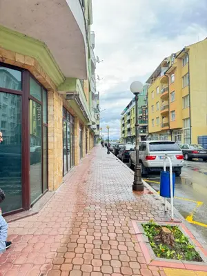 a cobblestone sidewalk in a city with buildings at Stan u moru in Pomorie