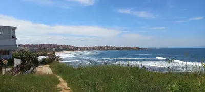 a view of a beach with buildings and the ocean at Созополи Хилс A11 in Sozopol