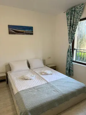 a bedroom with a large bed with a window at Marteo Apartments 105 - Sozopol in Sozopol