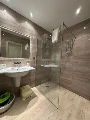 a bathroom with a sink and a glass shower at Marteo Apartments 105 - Sozopol in Sozopol