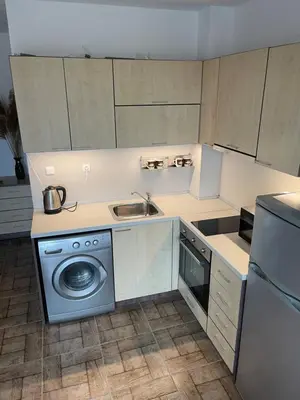a kitchen with a sink and a washing machine at Brymonte Studio, Sunny Day 6 in Tŭnkovo