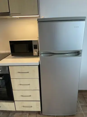 a refrigerator in a kitchen next to a microwave at Brymonte Studio, Sunny Day 6 in Tŭnkovo