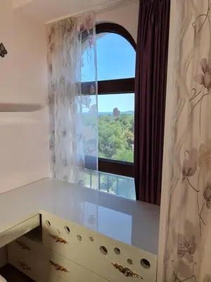 a window in a room with a desk and a window at Луксозен апартамент в Резиденция Лазурен бряг in Burgas City