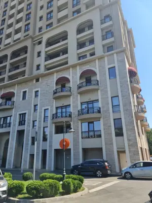 a building with cars parked in front of it at Луксозен апартамент в Резиденция Лазурен бряг in Burgas City