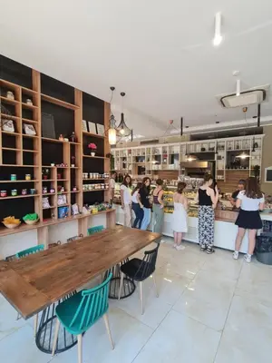 a group of people standing in a store with a table at Луксозен апартамент в Резиденция Лазурен бряг in Burgas City