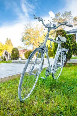 a bike parked in the grass in a yard at Хотел и Вили Марая apartament in Tsarevo