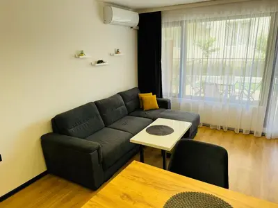 a living room with a couch and a table at CHERNO MORE 107 - 19 APARTMENT Nessebar in Nesebar