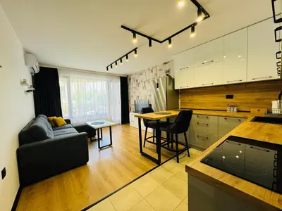a kitchen and living room with a couch and a table at CHERNO MORE 107 - 19 APARTMENT Nessebar in Nesebar