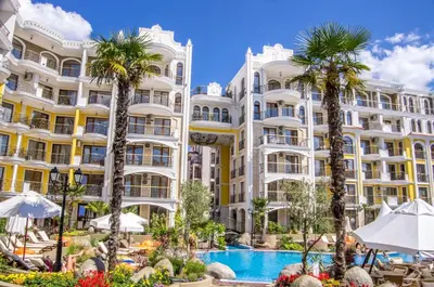 a hotel with a swimming pool and palm trees at 2 Room Apartment Harmony Suites Komplex in Sunny Beach