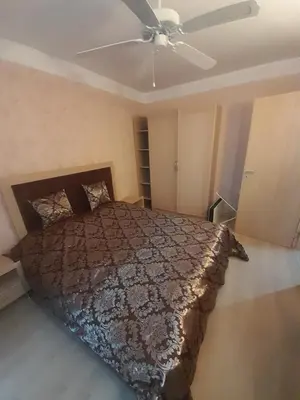 a bedroom with a bed and a ceiling fan at 2 Room Apartment Harmony Suites Komplex in Sunny Beach