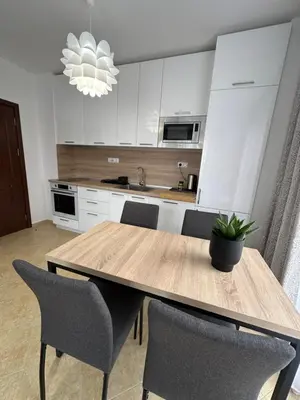 a kitchen with a wooden table and chairs at Cascadas family apartamant 2 in Sunny Beach