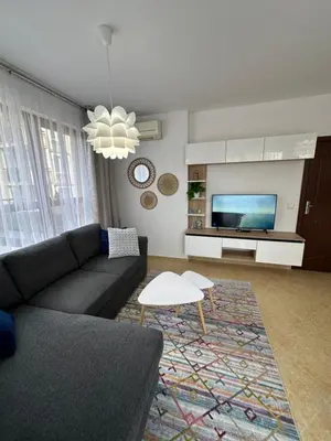 a living room with a couch and a tv at Cascadas family apartamant 2 in Sunny Beach