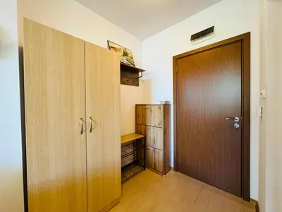 a room with a closet and a wooden door at GRAND KAMELIA B 2,8 Large Studio Sunny Beach in Sunny Beach