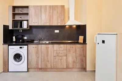 a kitchen with a sink and a washing machine at Апартамент Пенека in Pomorie