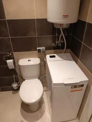 a bathroom with a white toilet and a sink at Royal Palm Studio, Sveti Vlas in Sveti Vlas