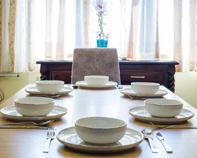 a wooden table with bowls and plates on it at Premium Lazur - Sea garden Burgas - TOP Location 5 min to the Beach in Burgas City