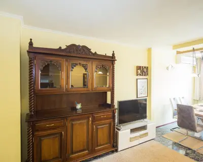 a large wooden entertainment center with a television in a living room at Premium Lazur - Sea garden Burgas - TOP Location 5 min to the Beach in Burgas City