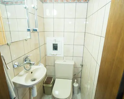 a small bathroom with a toilet and a sink at Premium Lazur - Sea garden Burgas - TOP Location 5 min to the Beach in Burgas City