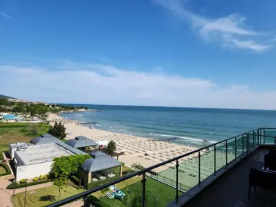 a view of a beach and the ocean from a balcony at APART SUNNY BAY a SUNNY BEACH in Sunny Beach