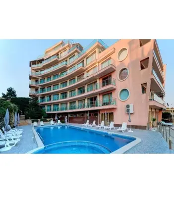 a large building with a swimming pool next to a building at APART SUNNY BAY a SUNNY BEACH in Sunny Beach
