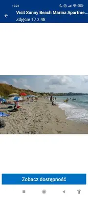 a picture of a beach with people in the water at Marina in Aheloy